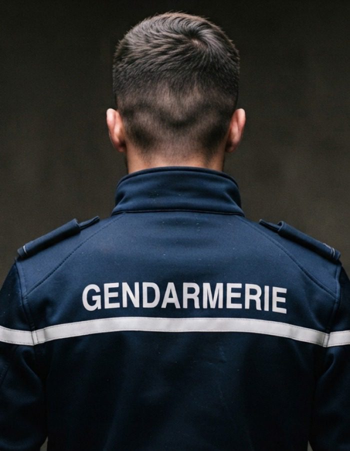 Gay man in uniform seen from behind, portrait evoking the origins and history of GayCharlie